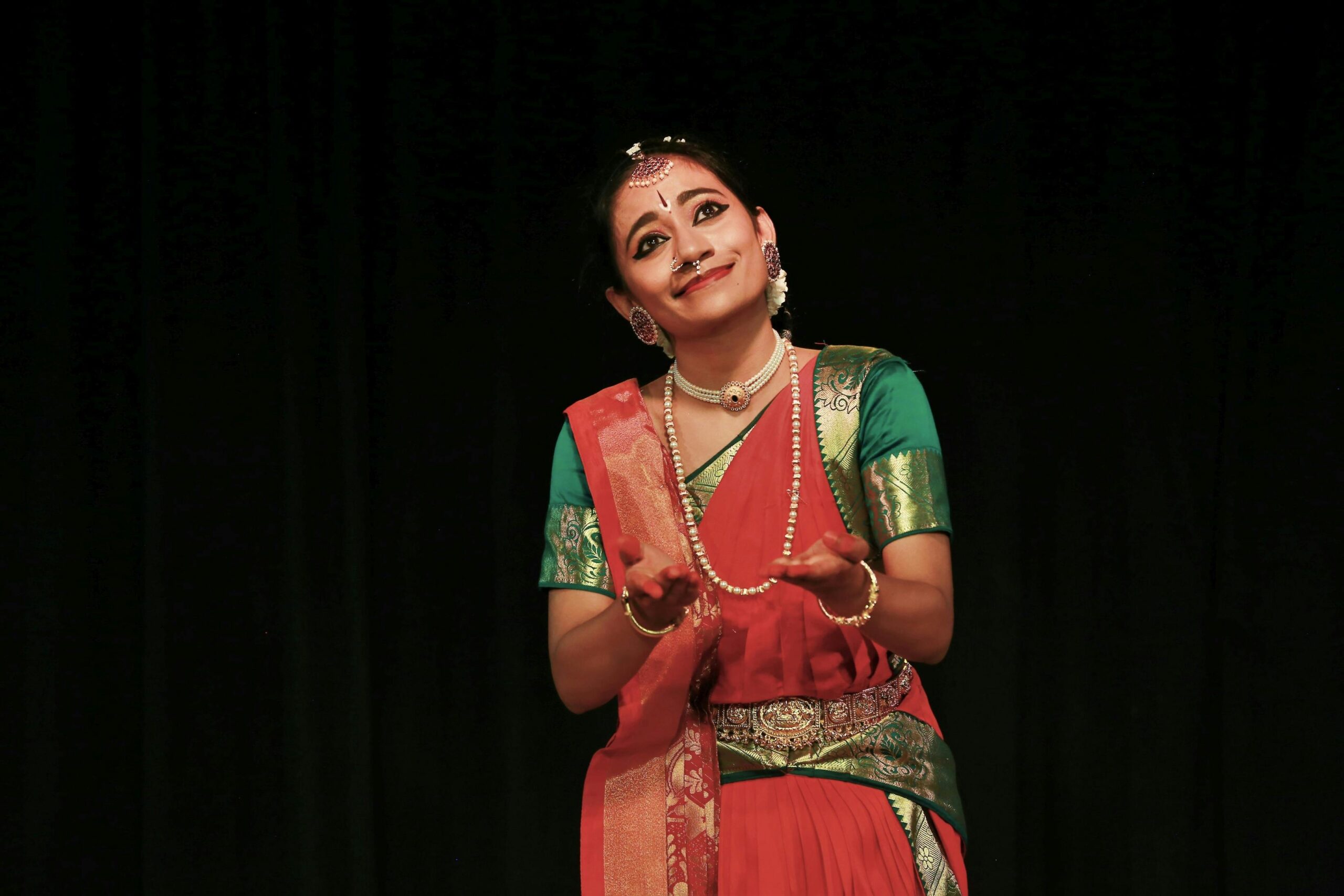 A captivating portrait of a woman performing Indian classical dance in traditional attire, exuding grace and cultural richness.